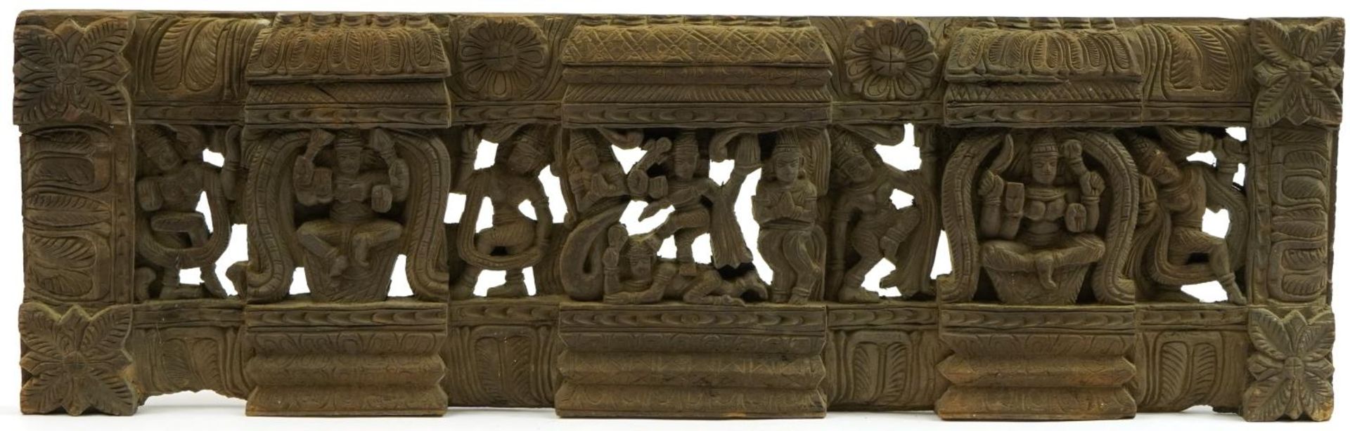 Burmese hardwood panel carved with deities and flowers, 76cm x 23cm