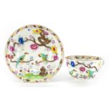 Early 19th century Swansea porcelain cup and saucer decorated with birds amongst flowers,