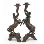 Pair of 19th century style patinated bronze candlesticks in the form of male and female centaurs,