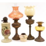 Four Victorian brass oil lamps and a Hinks & Sons ceramic reservoir, the largest 51cm high