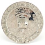 Islamic white metal plaque with calligraphy, signed to the reverse, 21.5cm in diameter