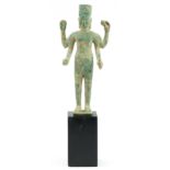 South East Asian verdigris bronze figure raised on a later ebonised block base, overall 45cm high