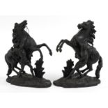 After Guillaume Coustou the Elder, Pair of patinated spelter Marly horses with trainers, 40cm high