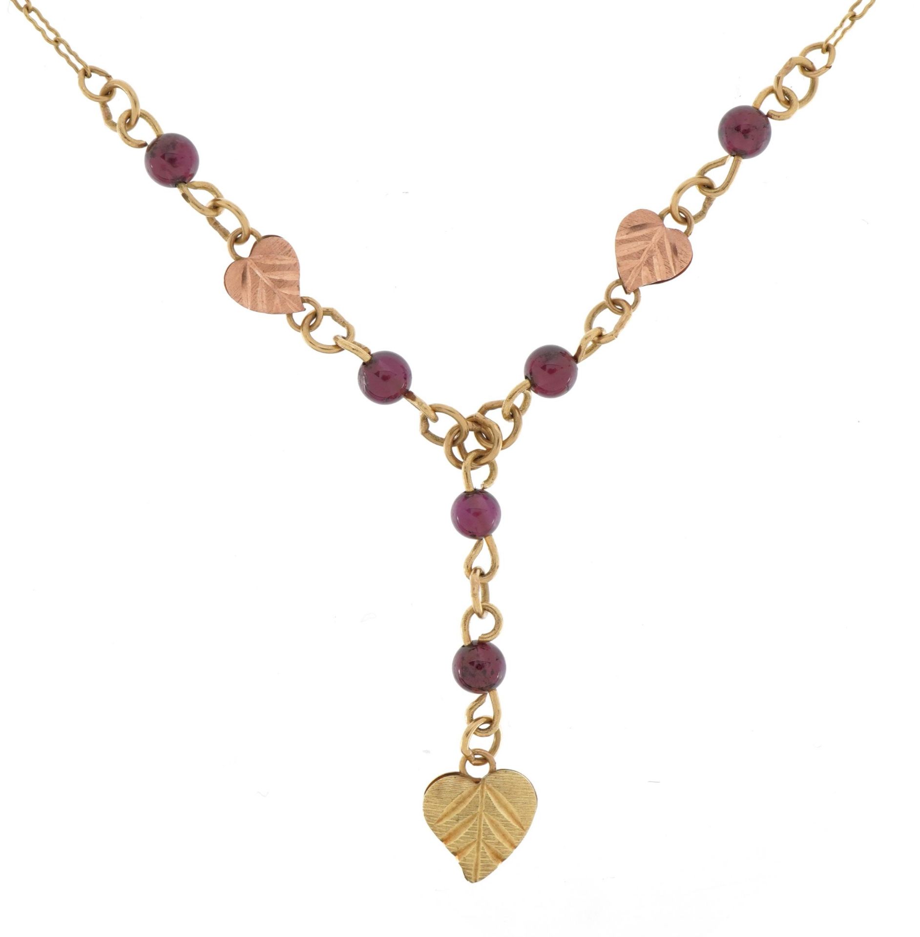 Manner of Black Hills, 9ct two tone gold garnet leaf design necklace, 44cm in length, 3.4g