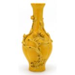 Chinese porcelain vase having a yellow glaze, decorated in relief with peaches, six figure character