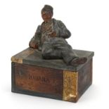 Early 20th century American interest Havana cigar box or humidor surmounted with a man holding a