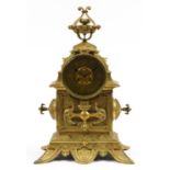 19th century bronze Gothic style mantle clock striking on a bell, with circular dial having Roman