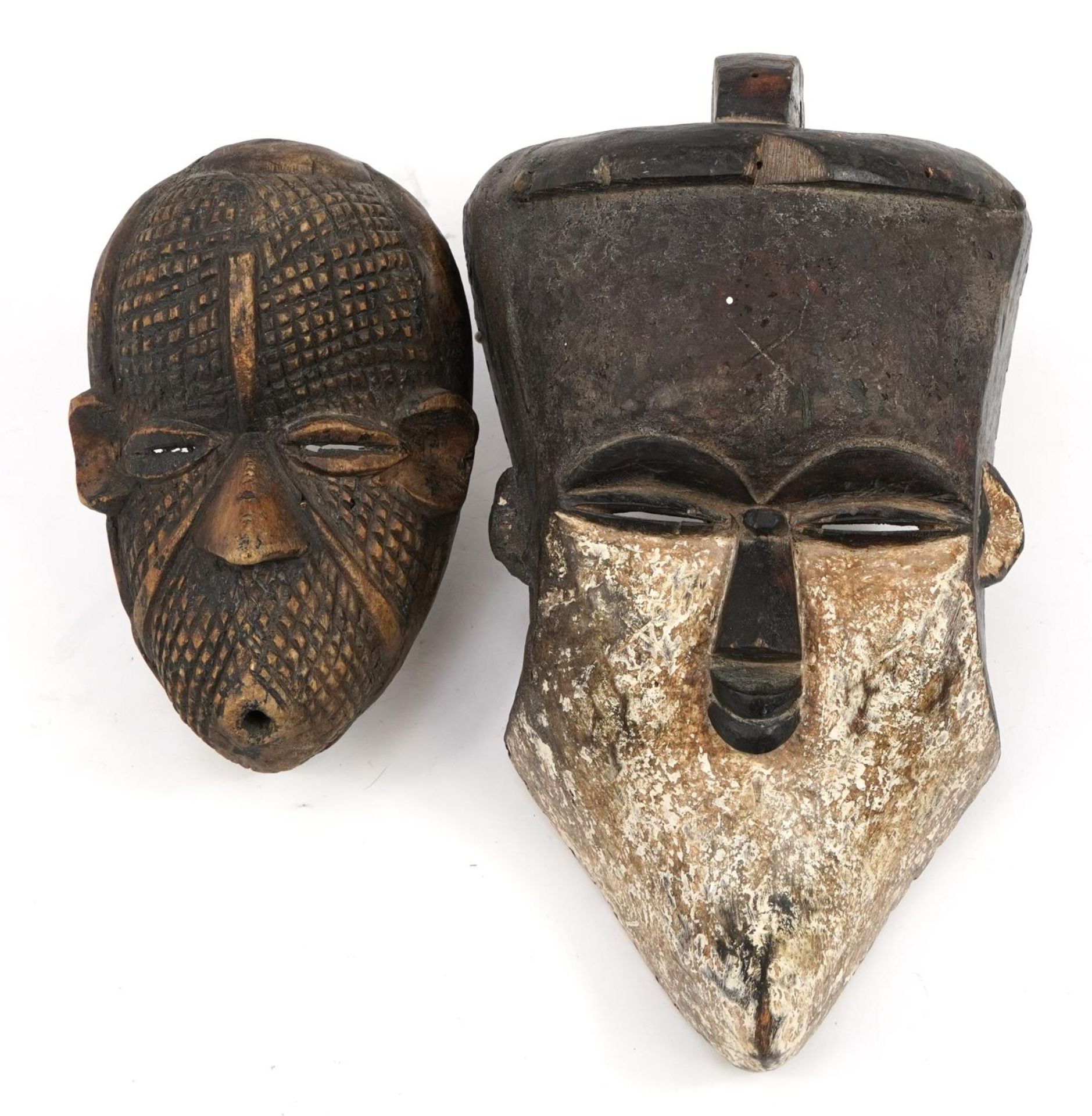 Two Tribal interest face masks including one with white paint, the largest 38cm high