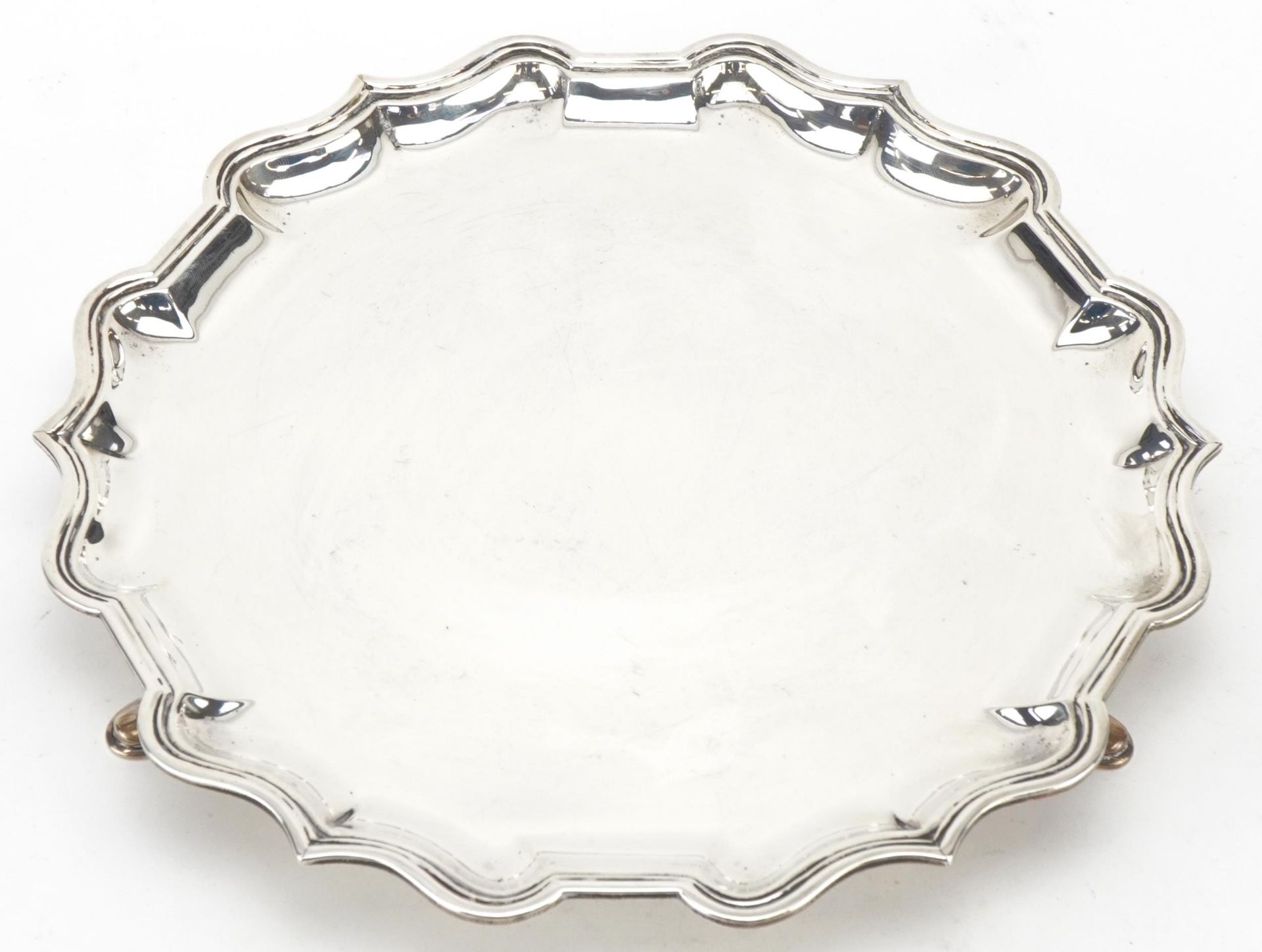 Hamilton & Inches, Scottish silver salver raised on three feet, Edinburgh 1910, 26cm in diameter,