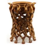African hardwood bowl carved with flowers housed in a puzzle design stand carved with animal