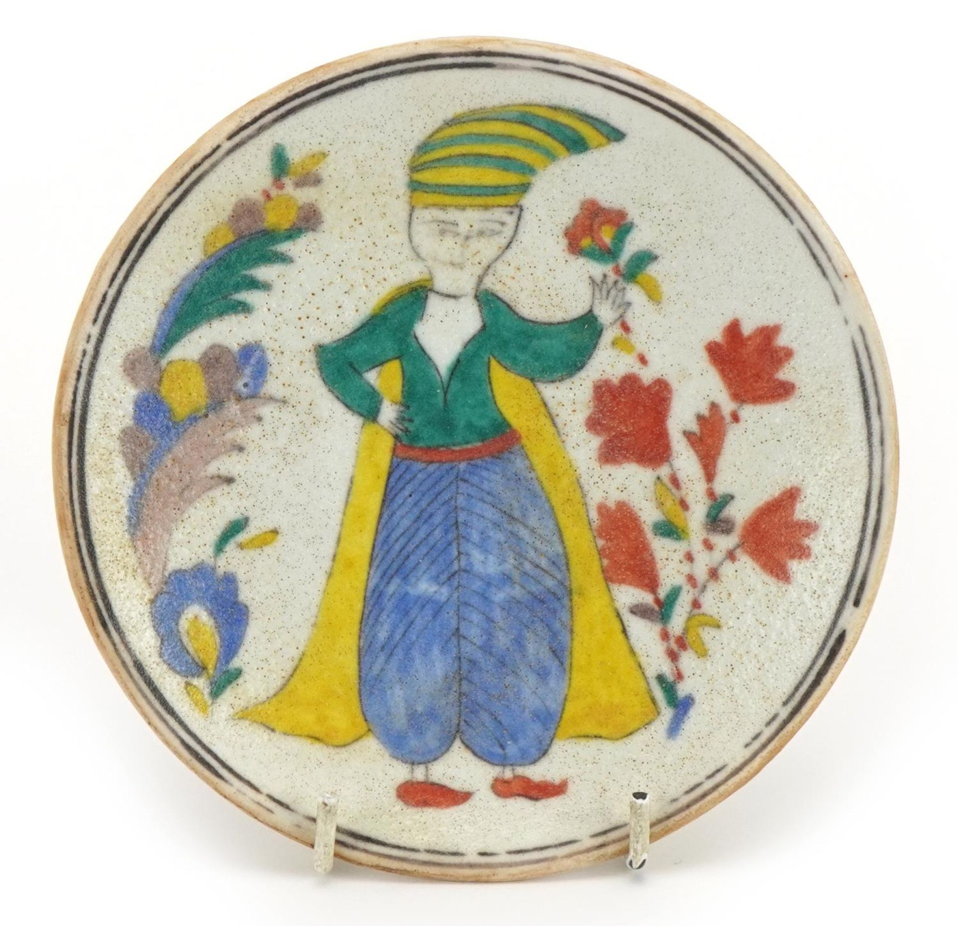 Turkish Kutahya pottery dish hand painted with a figures and flowers, 14cm in diameter
