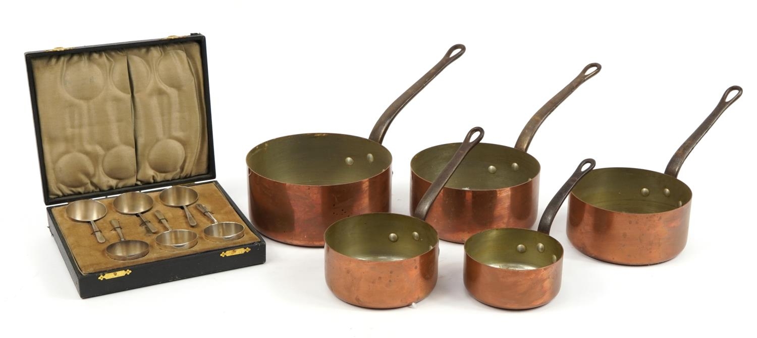 Graduated set of five 19th century copper and iron saucepans and a set of six silver plated preserve