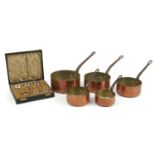 Graduated set of five 19th century copper and iron saucepans and a set of six silver plated preserve