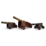 Three 19th century and later Naval interest bronze model table cannons on hardwood stands