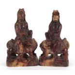 Good pair of Chinese soapstone carvings of Guanyin seated on a mythical animal, each 21cm high