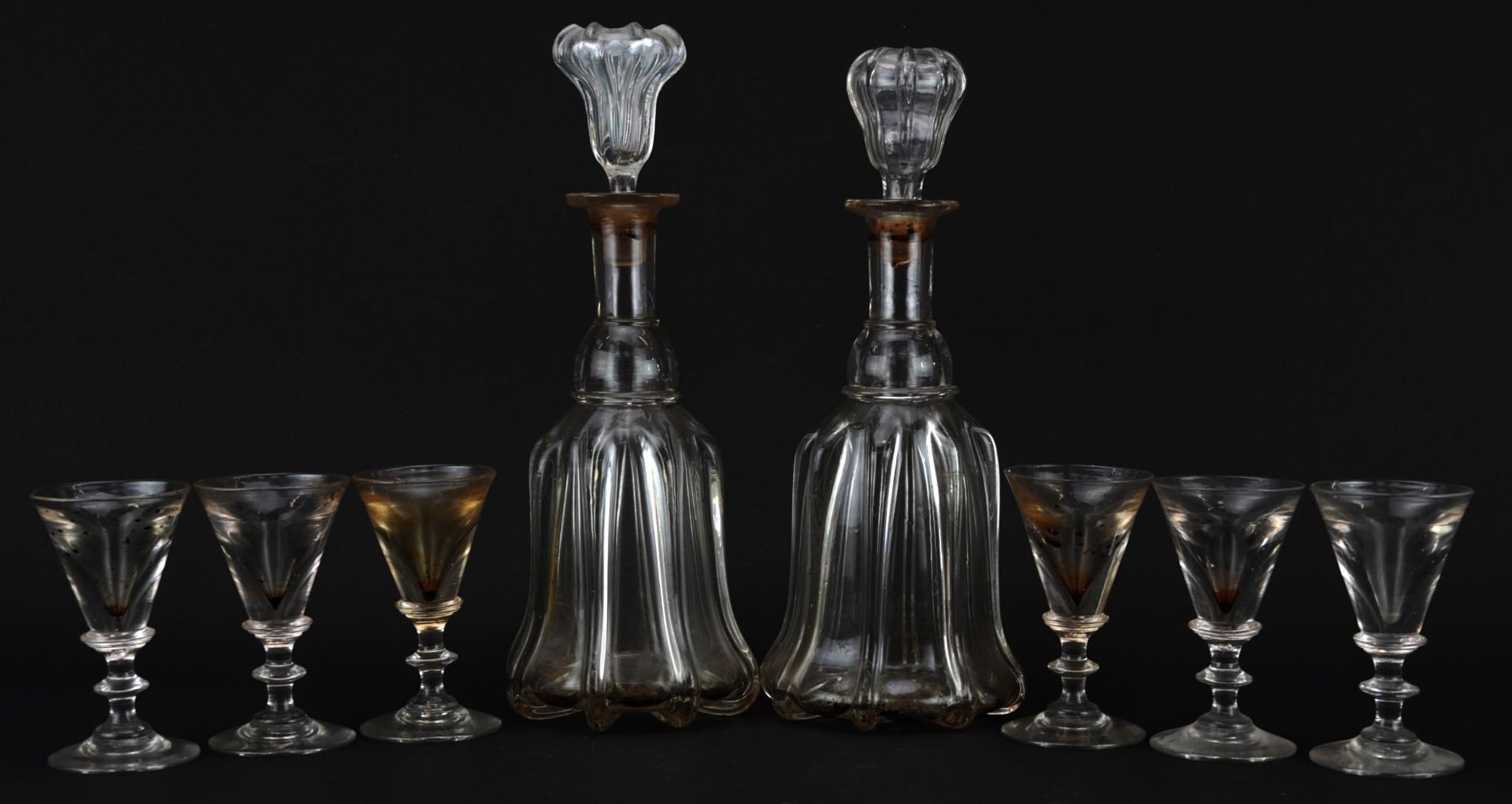 Set of six 18th century illusion glasses and a pair of decanters, the largest 31cm high