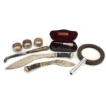 Objects including a gallery magnifying glass, silver handled knife, Kukri knives and white metal