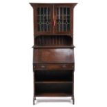 Arts and Crafts oak bureau bookcase with a pair of leaded glass doors, 183cm H x 80cm W x 33cm D