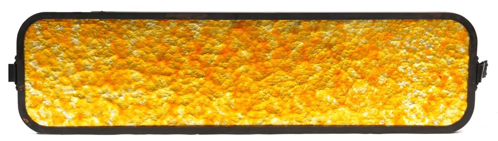 Large mottled amber stained glass panel with painted metal frame, 154cm x 41cm