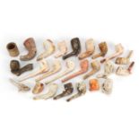 Collection of antique and later clay pipes including one in the form of a foot kicking a football