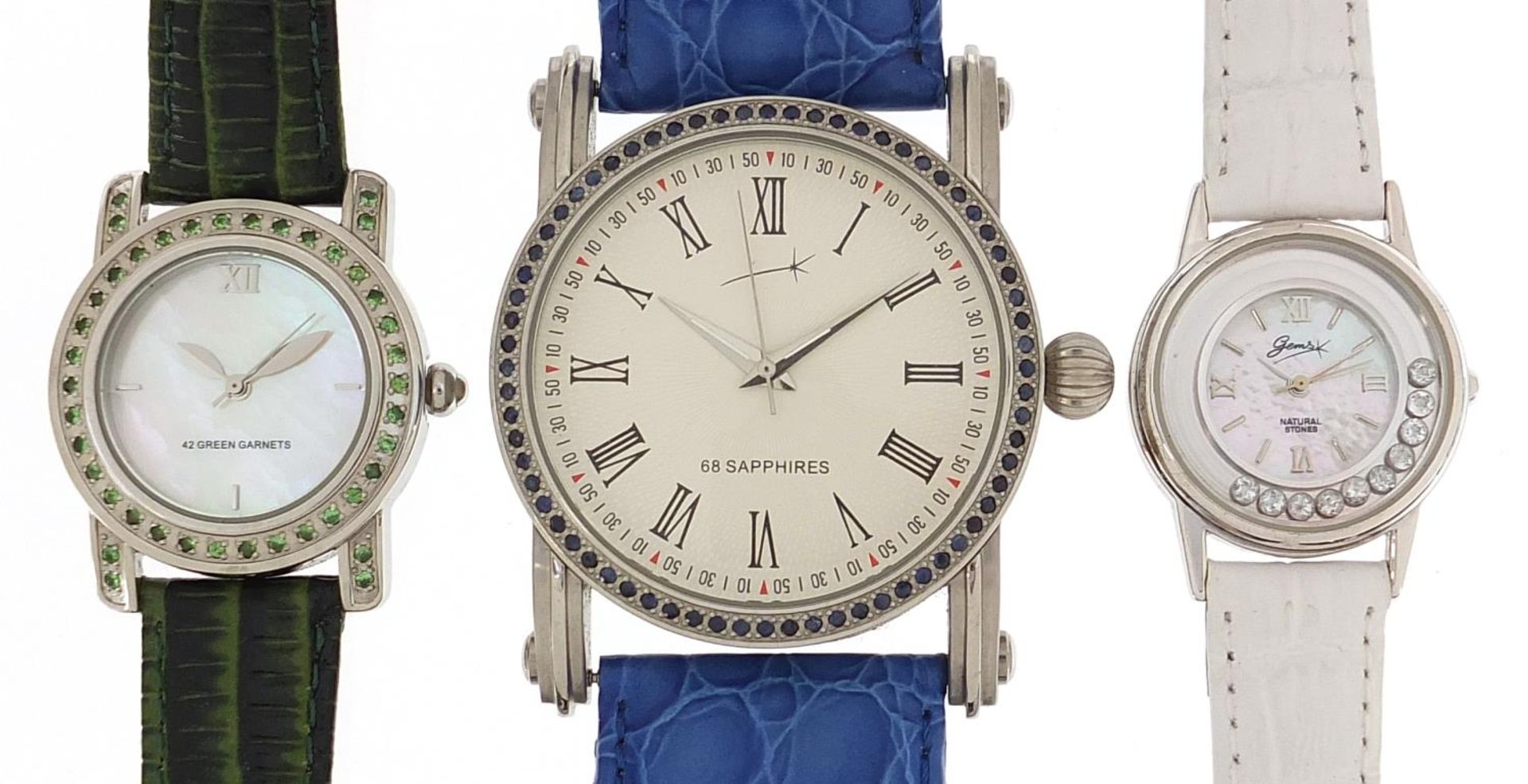 Three ladies wristwatches, one silver, each set with blue sapphires, topaz and aquamarine, with