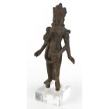 South East Asian patinated bronze goddess raised on a square Perspex block base, overall 36cm high