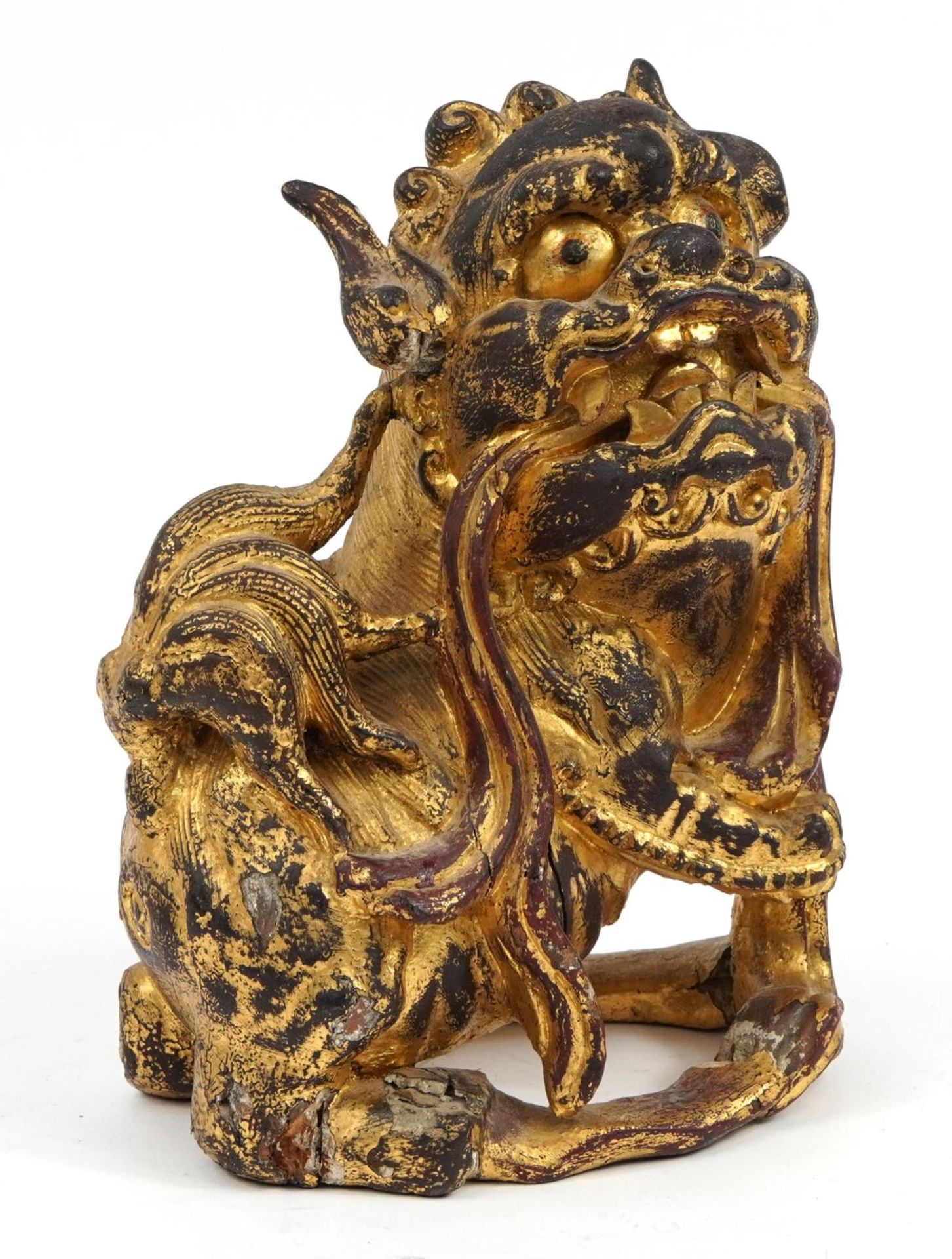 Chinese giltwood carving of a Foo dog, 30.5cm high