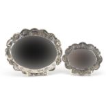 Two Turkish 900 grade silver vanity mirrors embossed with flowers, the largest 15.5cm wide