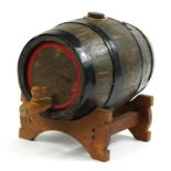 Breweriana interest metal bound oak barrel on stand with wooden tap, 42cm in length