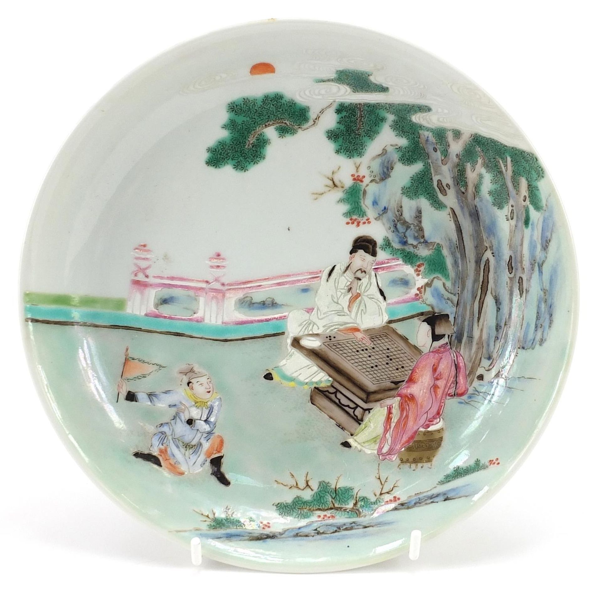 Chinese porcelain dish hand painted in the famille rose palette with an emperor and empress playing,