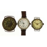 Three military interest trench watches, two silver with enamel dials, the largest 30mm in diameter