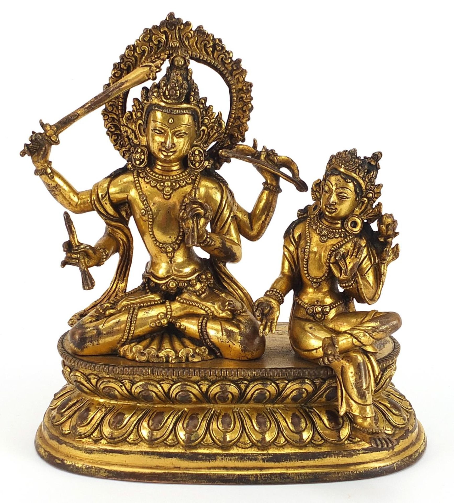Chino Tibetan gilt bronze figure of two deities sitting on a lotus leaf, 16cm wide
