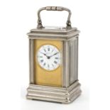 Drocourt, French miniature silvered brass carriage clock with circular enamelled dial having Roman