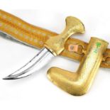 Omani ceremonial gilt metal jambiya dagger on embroidered belt, the dagger 27cm high