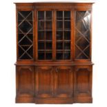 Oak breakfront bookcase with four glazed doors above four cupboard doors, 190cm H x 150cm W x 44cm D