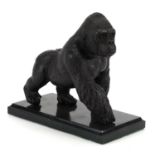 Patinated bronze gorilla raised on a black marble base, 20cm in length