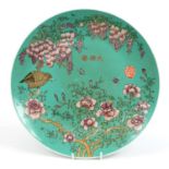 Chinese porcelain turquoise ground charger hand painted with a quail amongst flowers, four figure