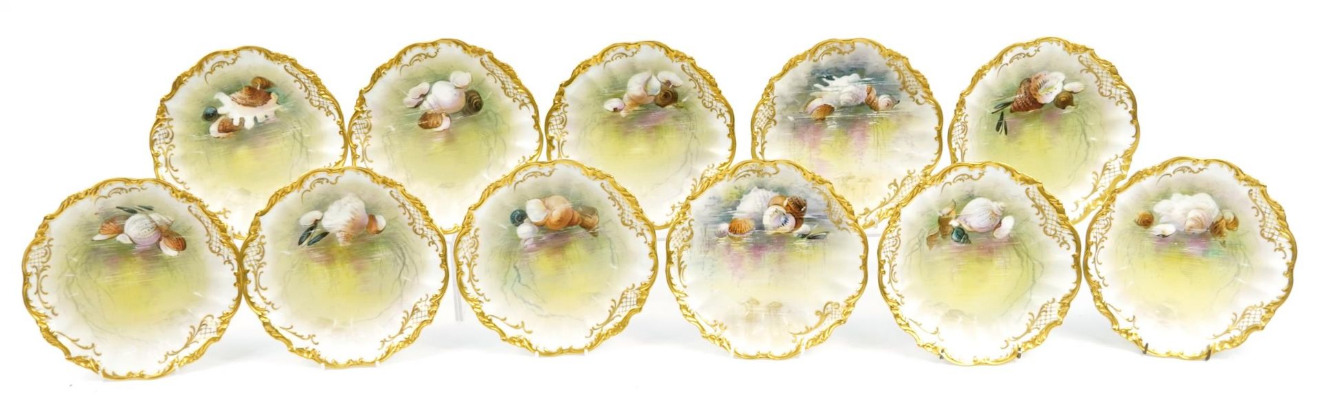 Limoges, Ten French porcelain desert plates with gilt borders, each hand painted with shells and