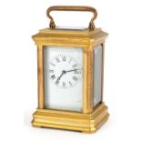 Miniature brass carriage clock with enamelled dial having Roman numerals numbered 3010 to the