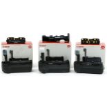 Three Canon battery grips with boxes comprising BG-E7, BG-E2N and BG-B16