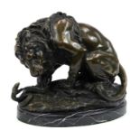 Large patinated bronze study of a lion and serpent signed A Barye, raised on an oval marble base