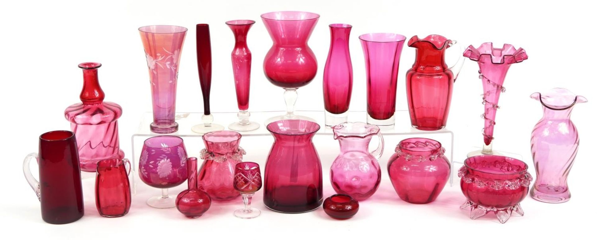 Collection of Victorian and later cranberry glass vases, jugs and glasses, the largest 22cm high