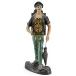 Novelty painted spelter table clock in the form of a gentleman with an umbrella, 43.5cm high