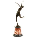 Large patinated bronze figurine of an Art Deco female dancing raised on a tapered marble and black