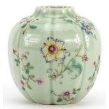 Chinese porcelain vase having a celadon glaze hand painted in the famille rose palette with flowers,