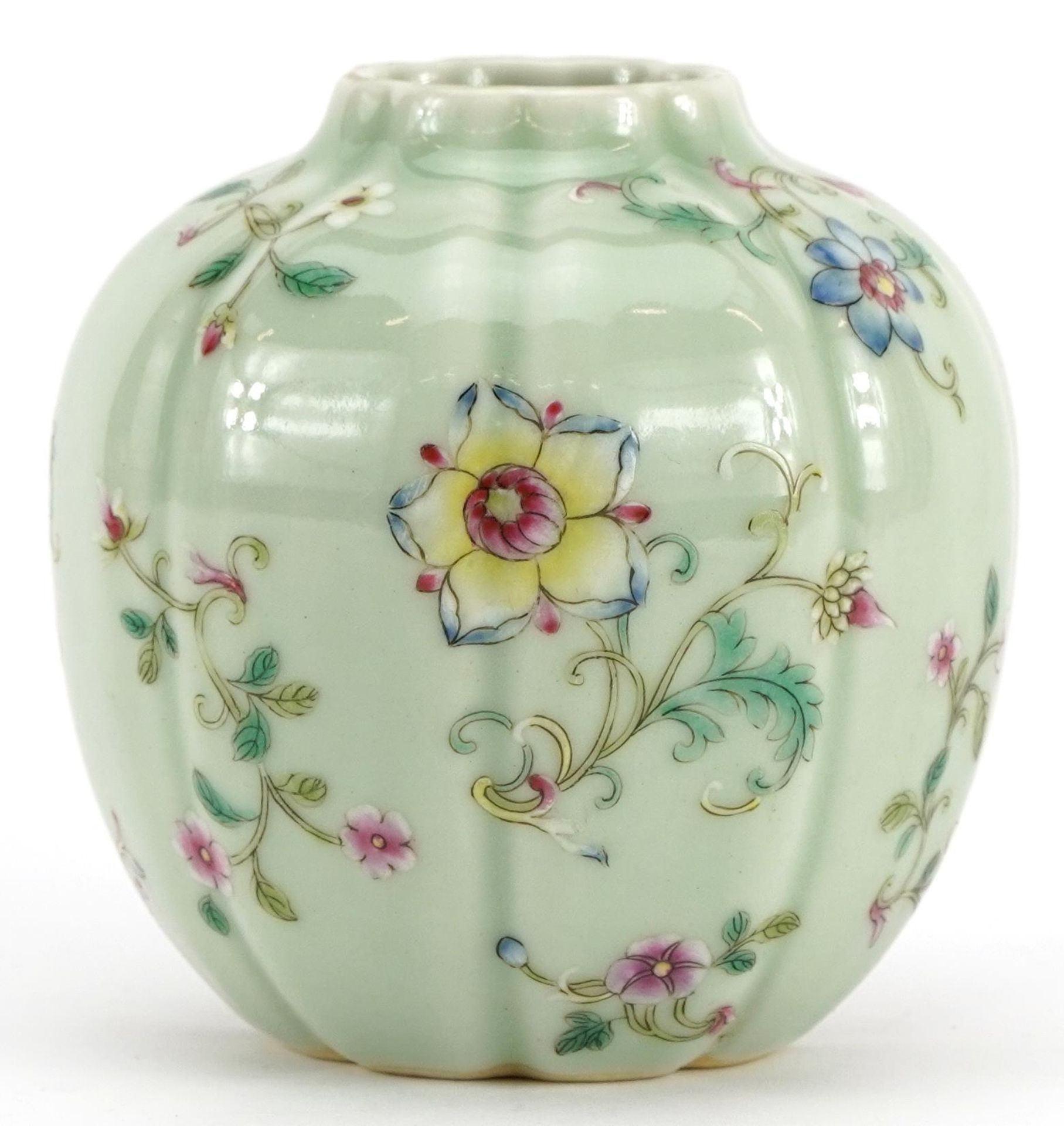 Chinese porcelain vase having a celadon glaze hand painted in the famille rose palette with flowers,