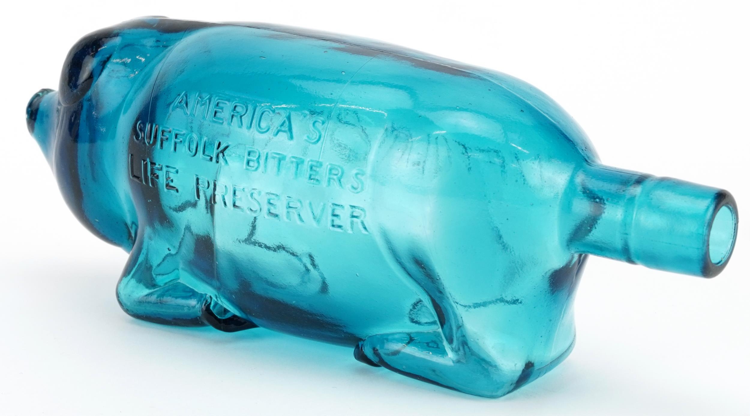 Blue glass bottle in the form of a pig advertising Suffolk Bitters, 24cm in length - Image 2 of 3