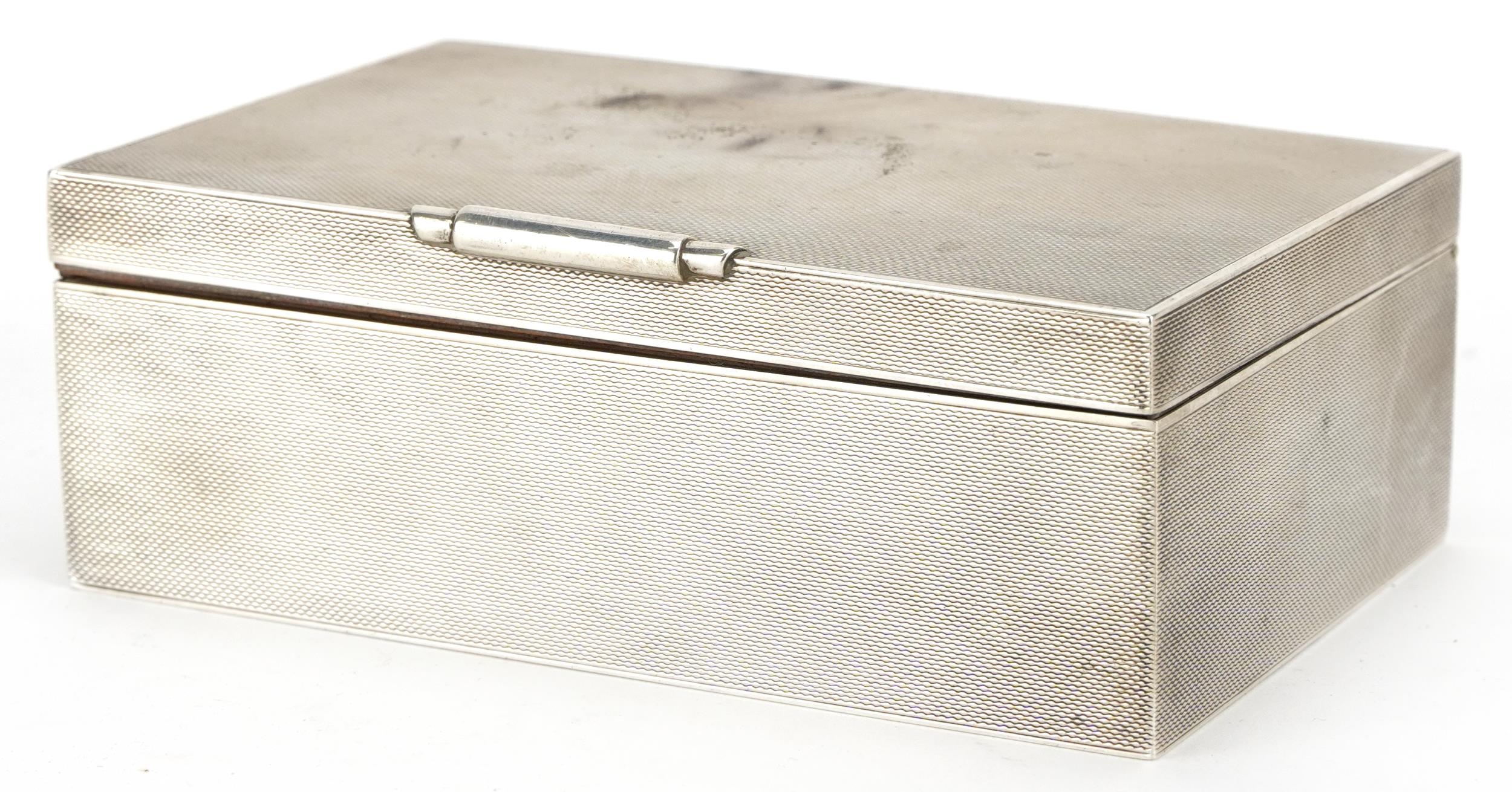 W H Manton, Elizabeth II Art Deco style silver cigarette box with engine turned decoration,