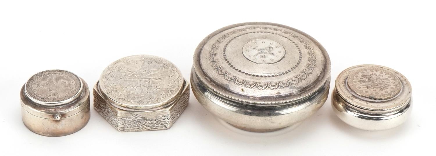 Four Persian silver coin set pill boxes and trinkets, each with impressed marks, the largest 6.2cm