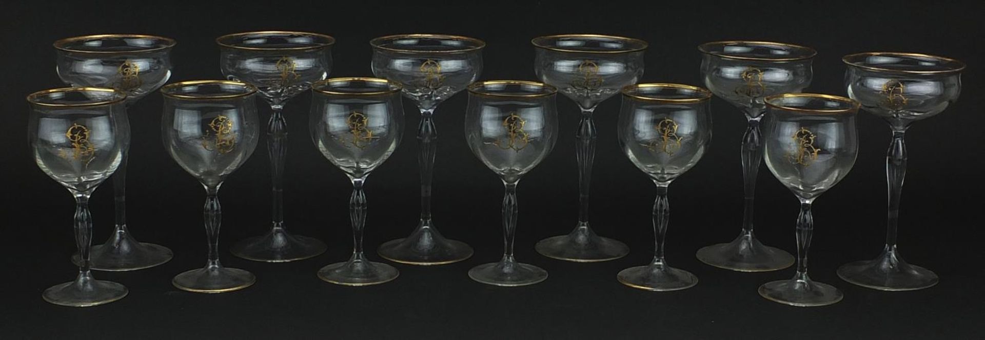 Two sets of six Venetian glasses with gilt monograms and borders, the largest each 18cm high